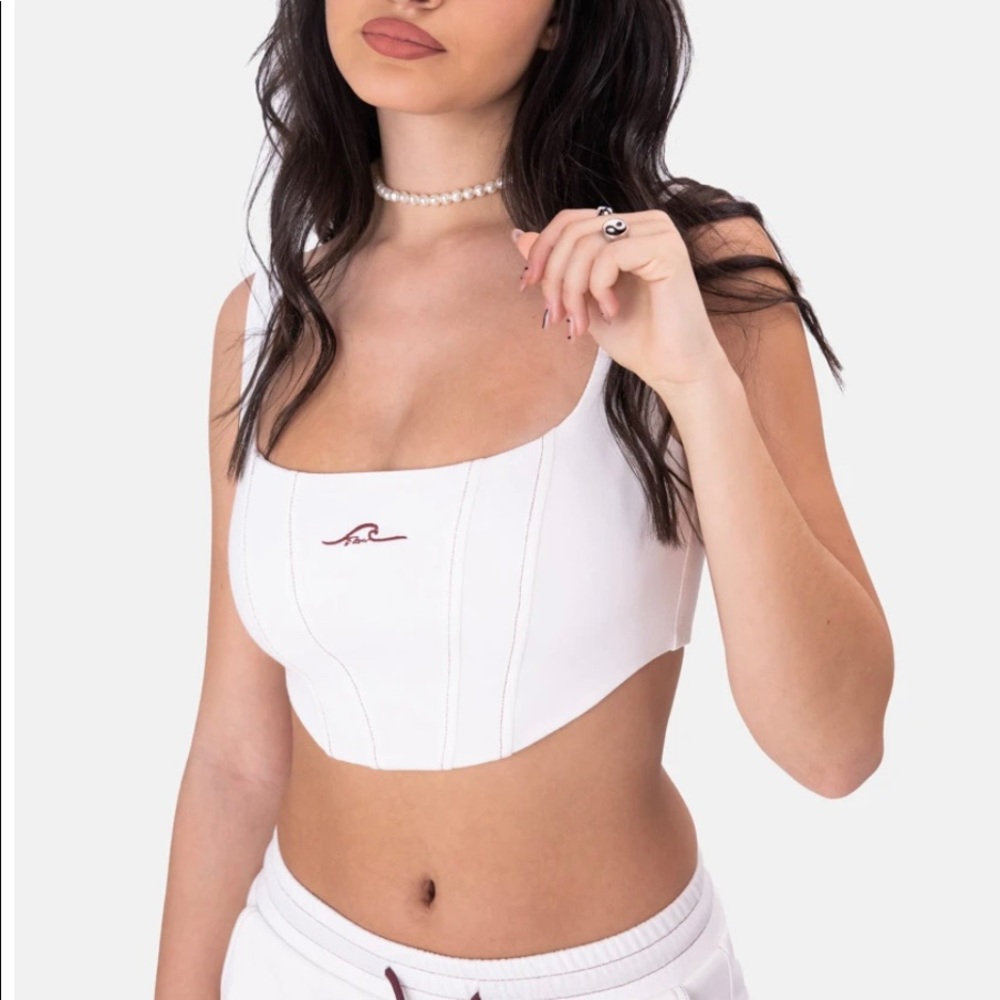White corset style crop top with maroon wave detail on chest from Adika!